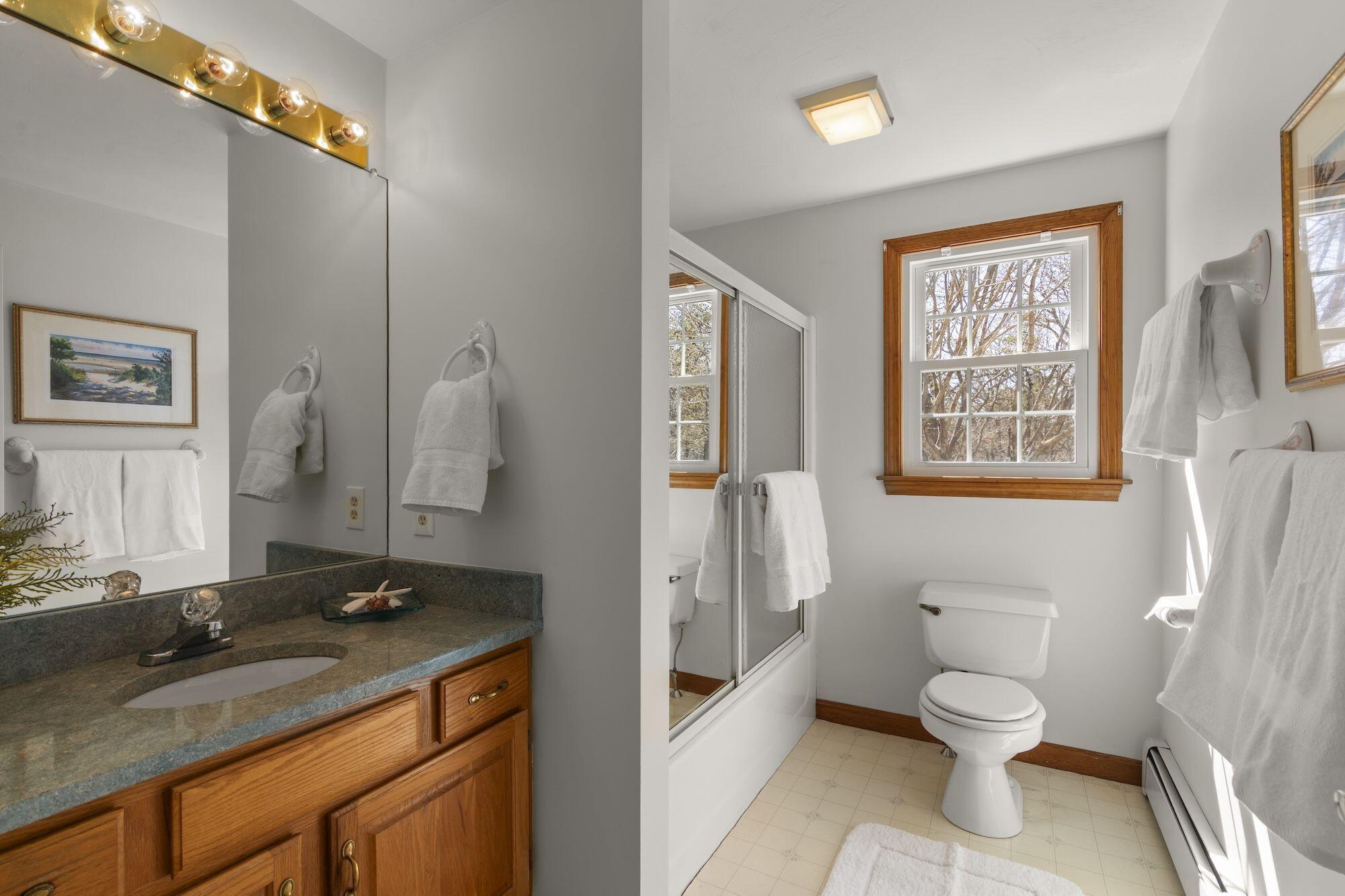 263 Spruce Road Harwich, MA 02645 - Photo 20 of 53 a bathroom with a granite countertop toilet a sink and a mirror