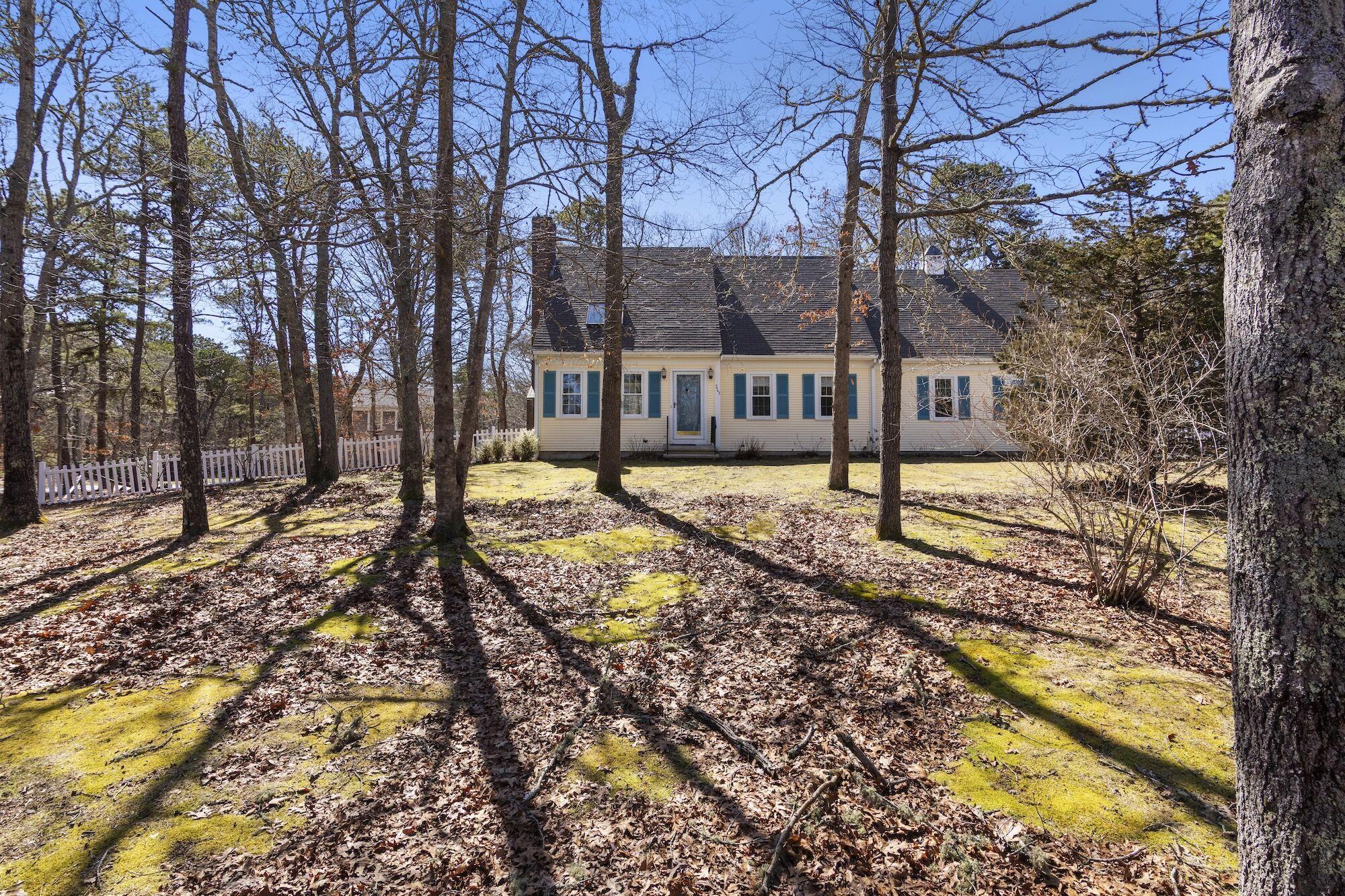 263 Spruce Road Harwich, MA 02645 - Photo 2 of 53 a view of a yard with trees and sitting area