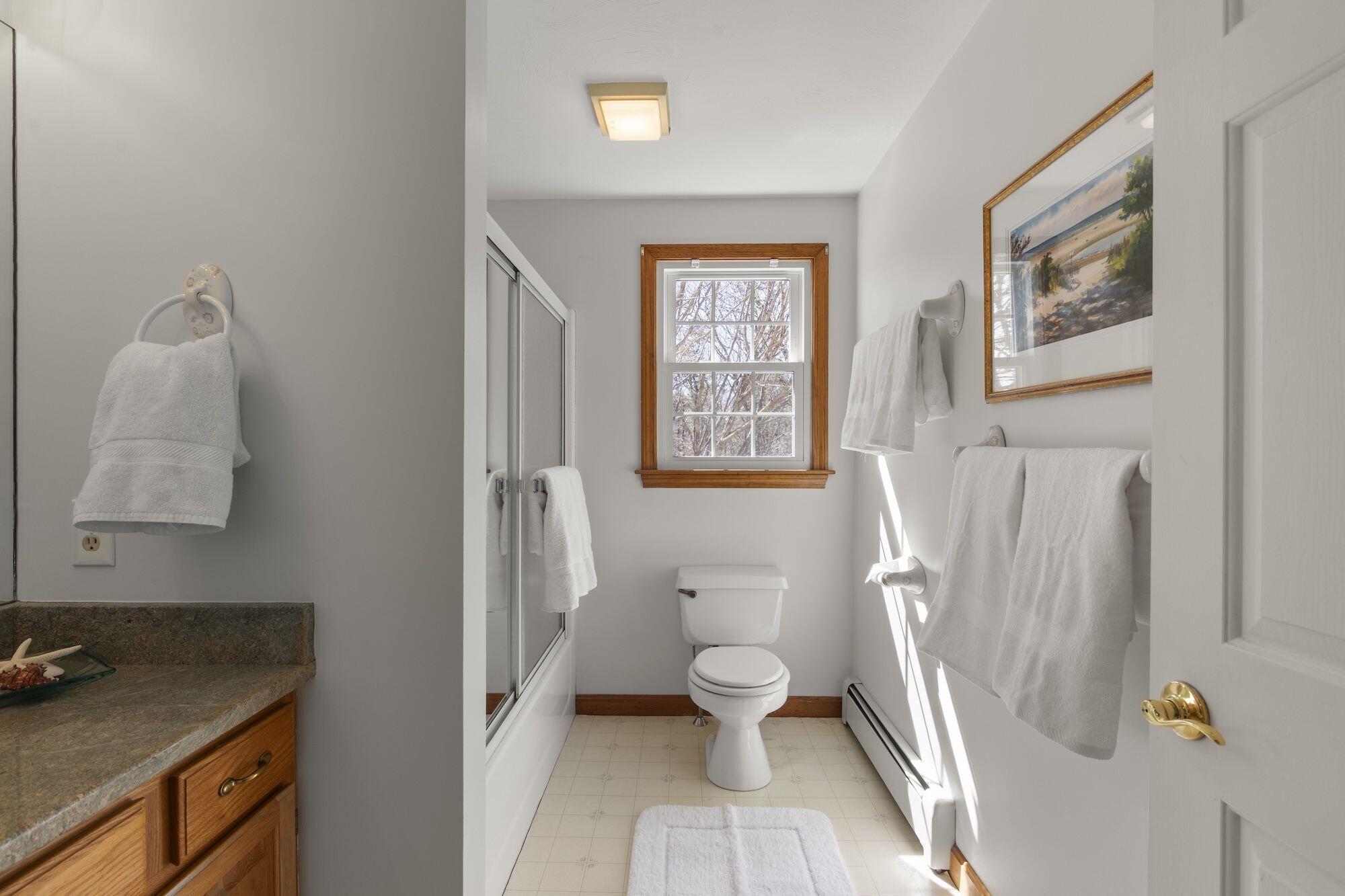 263 Spruce Road Harwich, MA 02645 - Photo 21 of 53 a bathroom with a granite countertop sink toilet and painting on the wall