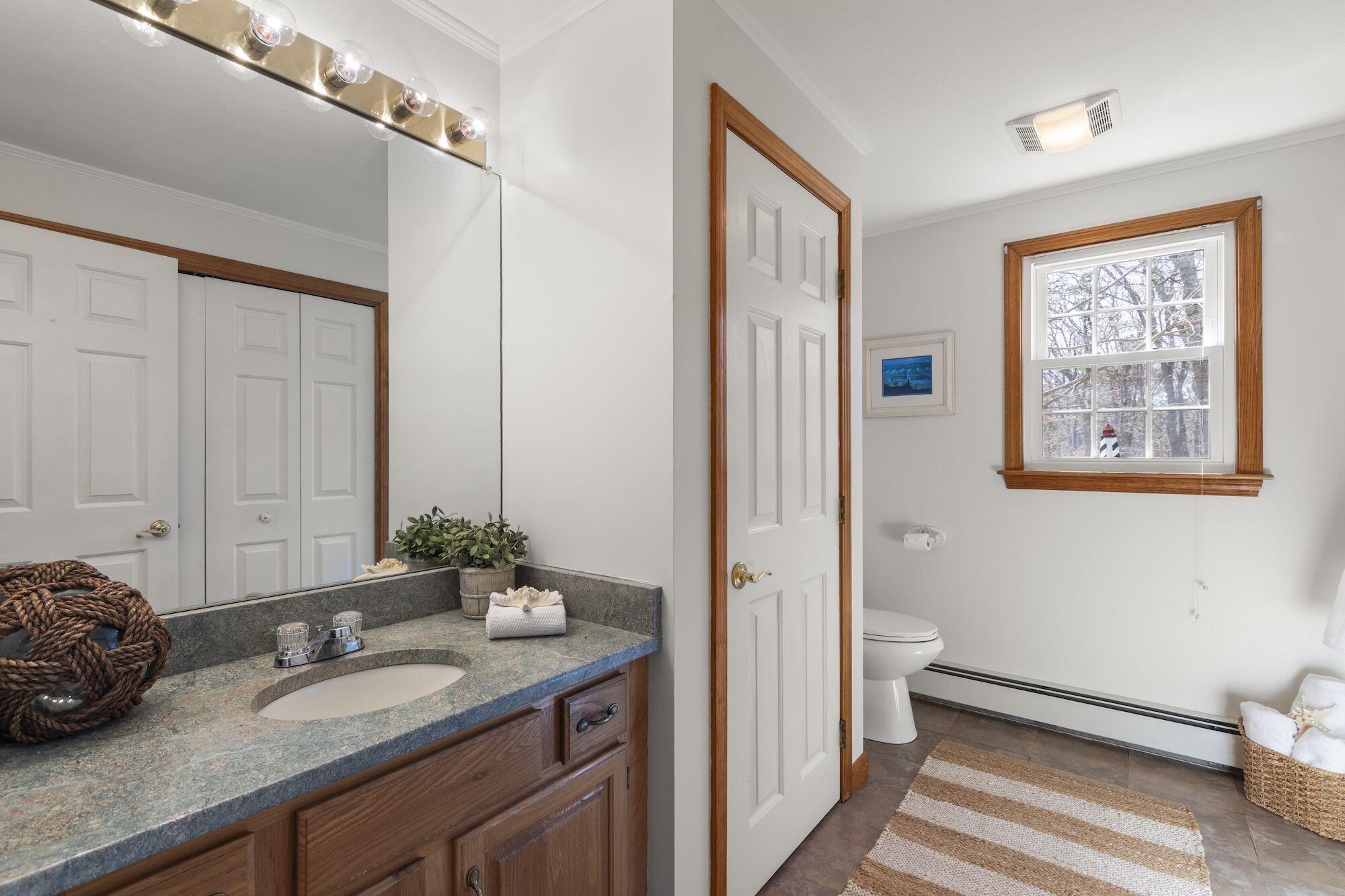 263 Spruce Road Harwich, MA 02645 - Photo 26 of 53 a spacious bathroom with a granite countertop sink and a mirror