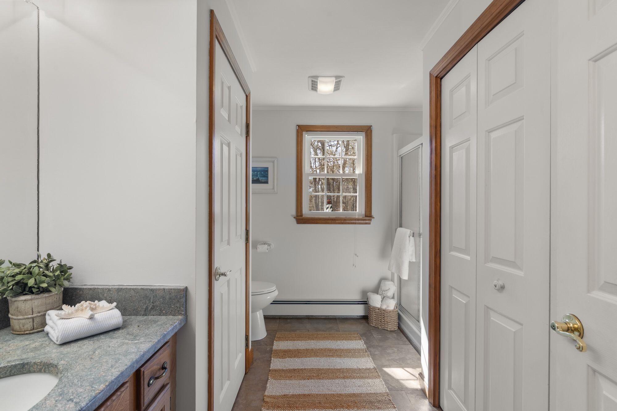 263 Spruce Road Harwich, MA 02645 - Photo 27 of 53 a bathroom with a granite countertop sink and a mirror