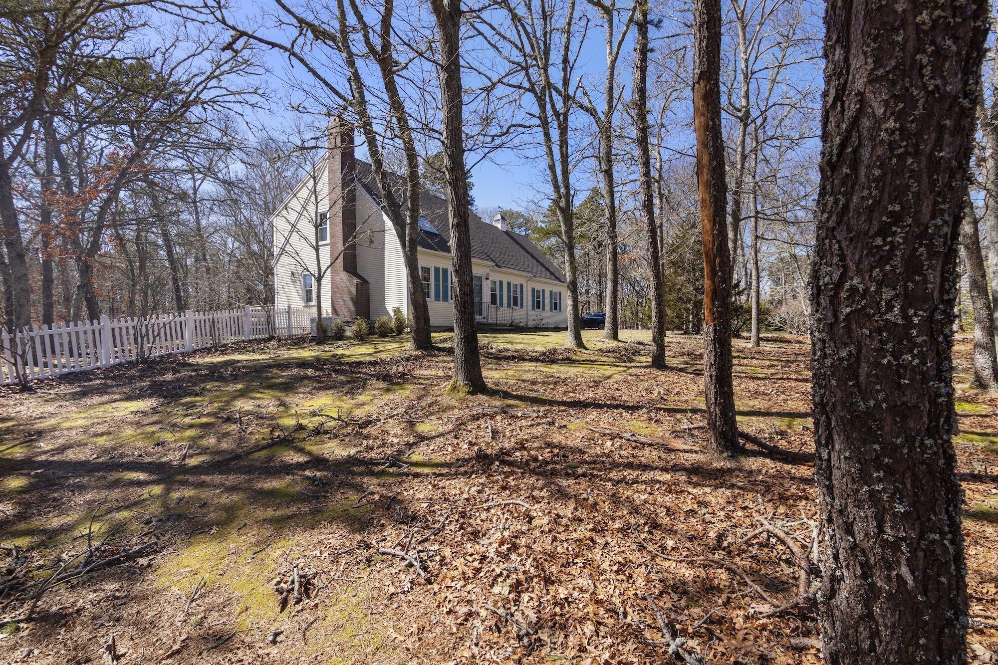 263 Spruce Road Harwich, MA 02645 - Photo 44 of 53 a backyard of a house with lots of green space