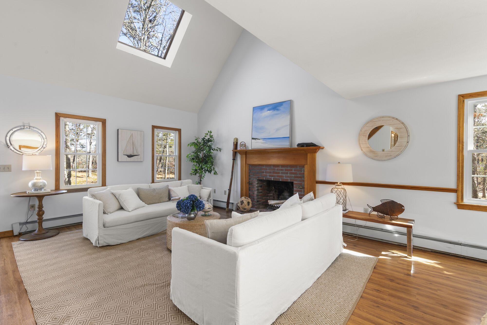 263 Spruce Road Harwich, MA 02645 - Photo 6 of 53 a living room with furniture and a fireplace