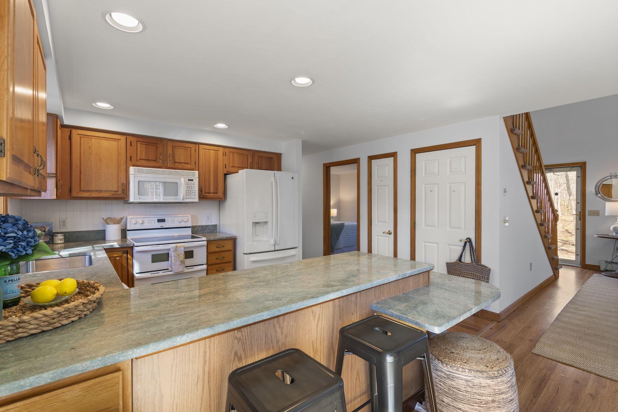 263 Spruce Road Harwich, MA 02645 - Photo 10 of 53 a kitchen with stainless steel appliances granite countertop a sink refrigerator and cabinets