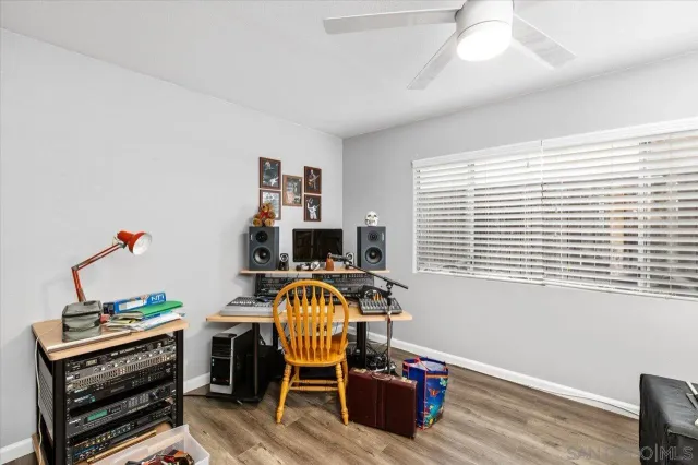 a view of a workspace with furniture and a window