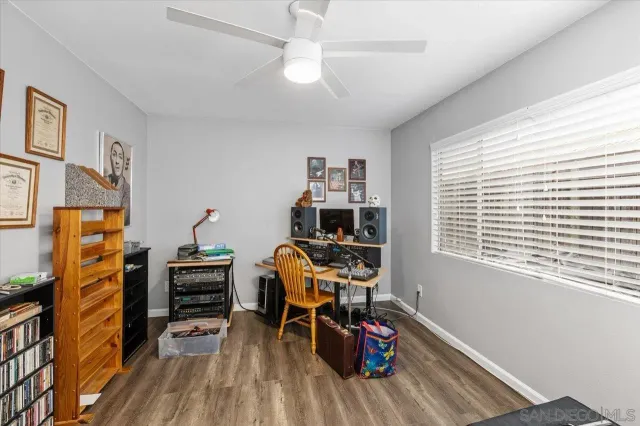 a view of a workspace with furniture and a window