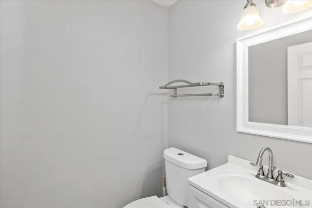a white toilet sitting next to a bathroom sink
