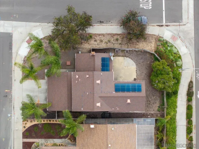 an aerial view of a house with a yard and a fountain