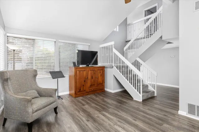 a livingroom with furniture staircase and windows