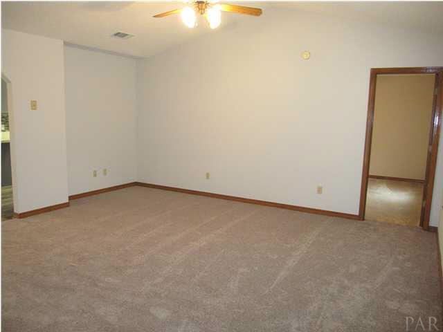 4240 Galt City Road Milton, FL 32583 - Photo 13 of 25 Family room with NEW carpet installed Feb. 2013. Master suite entrance to your right.