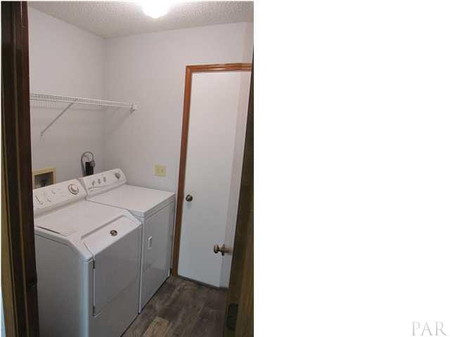 4240 Galt City Road Milton, FL 32583 - Photo 19 of 25 Laundry room with door leading out to the garage. NEW flooring Feb. 2013