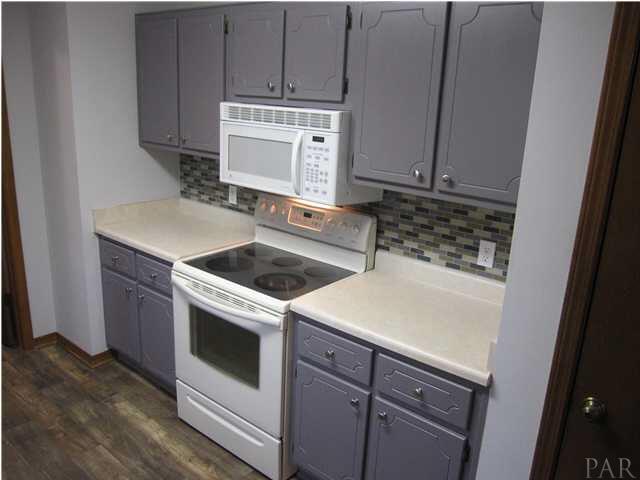 4240 Galt City Road Milton, FL 32583 - Photo 8 of 25 New brushed nickel hardware is a nice addition to the freshly painted cabinets & new tile backsplash!
