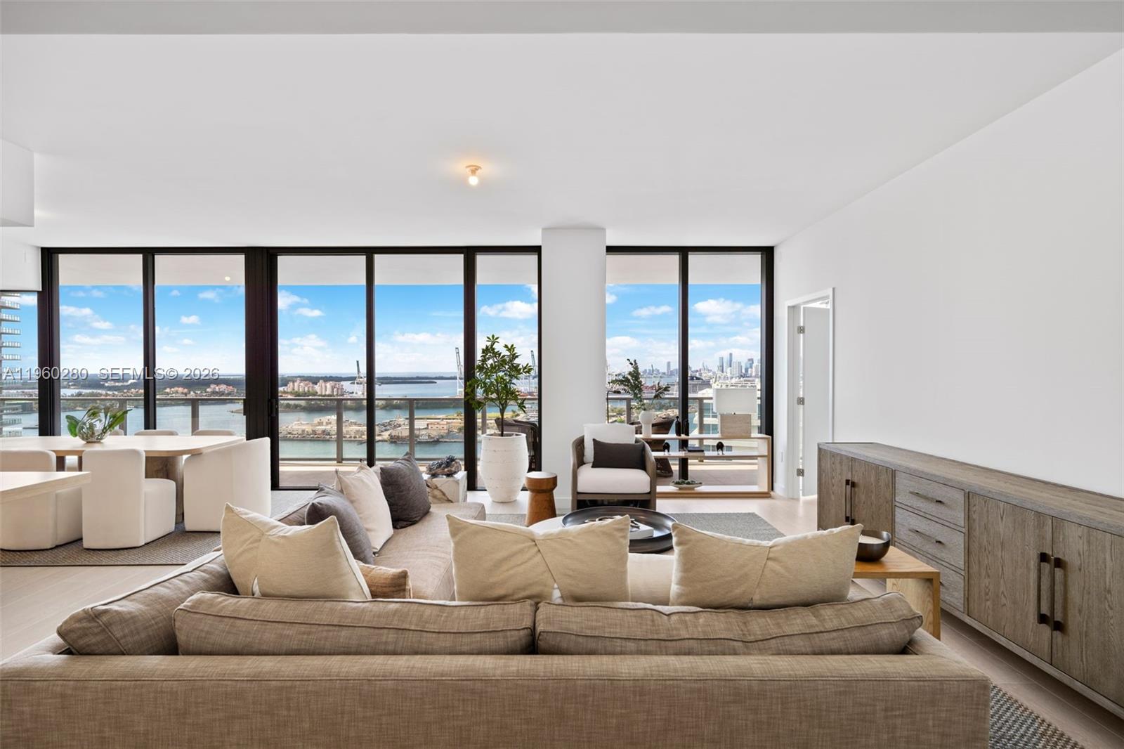 a living room with furniture and large windows