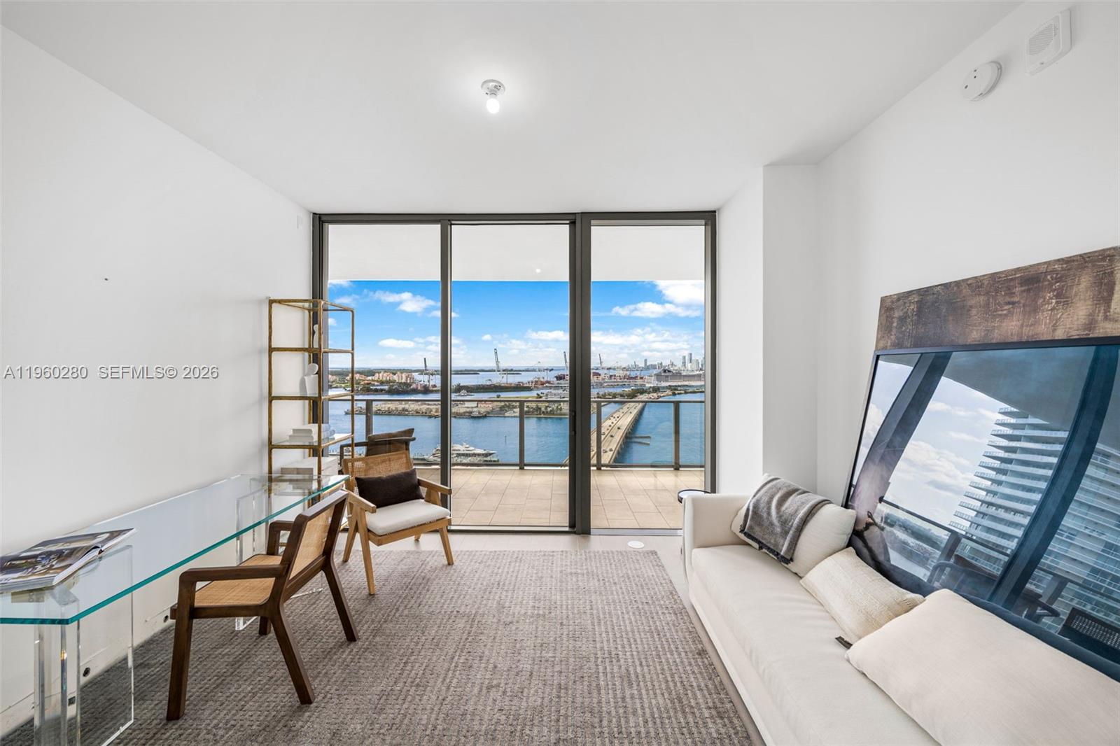 500 Alton Road, Unit 2203 Miami Beach, FL 33139 - Photo 16 of 36 a living room with furniture and a floor to ceiling window