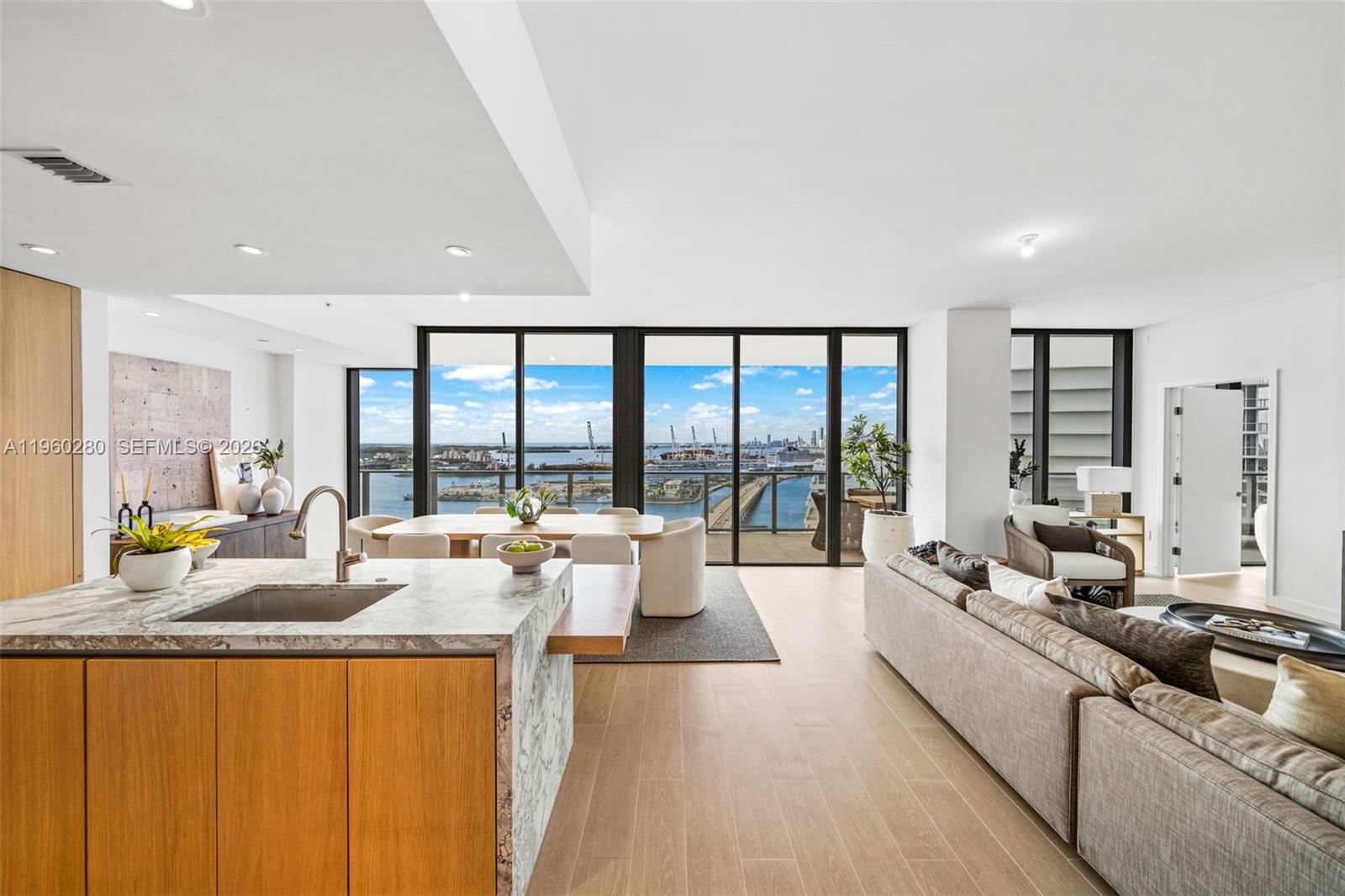 500 Alton Road, Unit 2203 Miami Beach, FL 33139 - Photo 2 of 36 a large living room with furniture and large windows