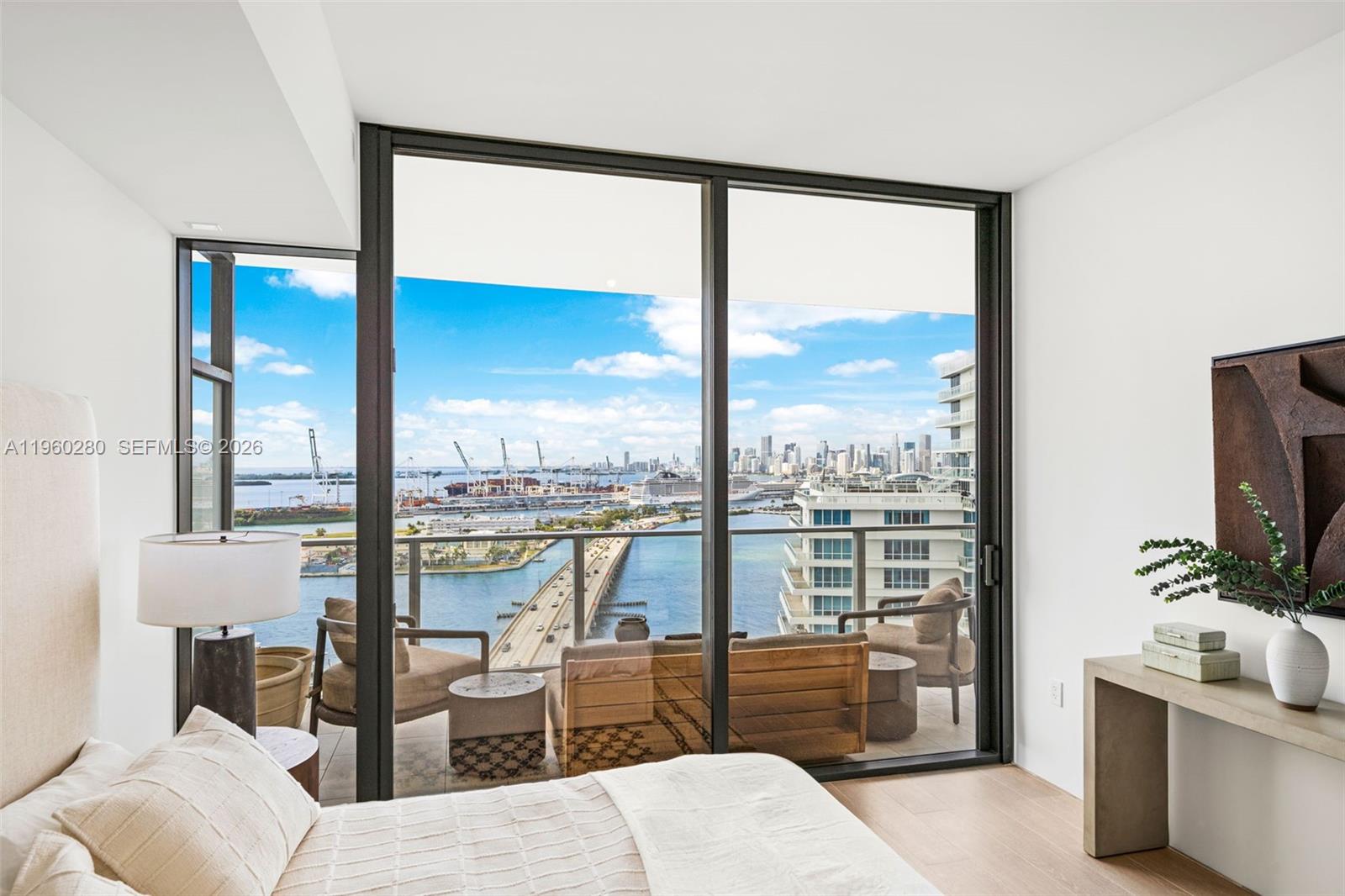500 Alton Road, Unit 2203 Miami Beach, FL 33139 - Photo 21 of 36 a living room with patio furniture and a flat screen tv