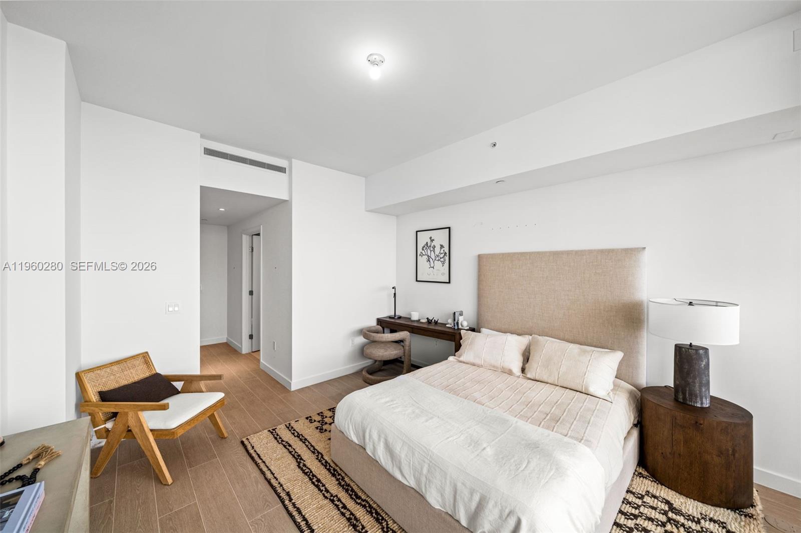 500 Alton Road, Unit 2203 Miami Beach, FL 33139 - Photo 22 of 36 a bedroom with a bed and wooden floor