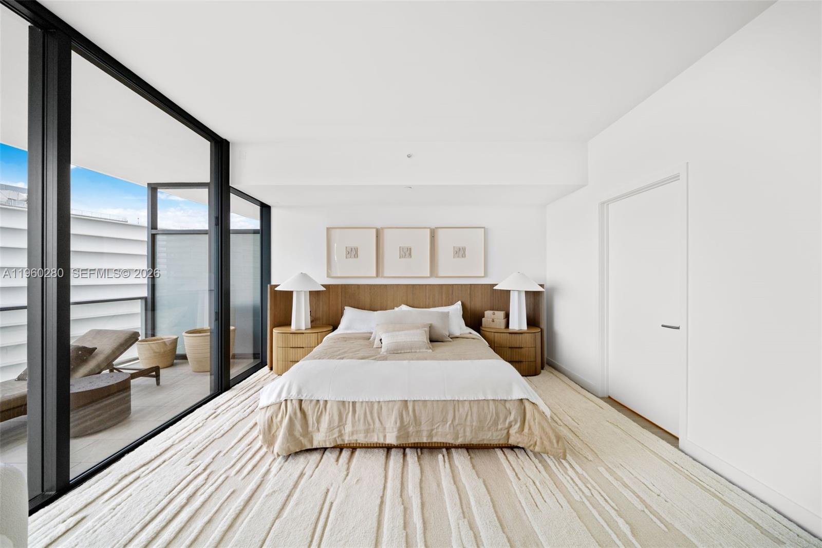 500 Alton Road, Unit 2203 Miami Beach, FL 33139 - Photo 27 of 36 a bedroom with a bed and wooden floor