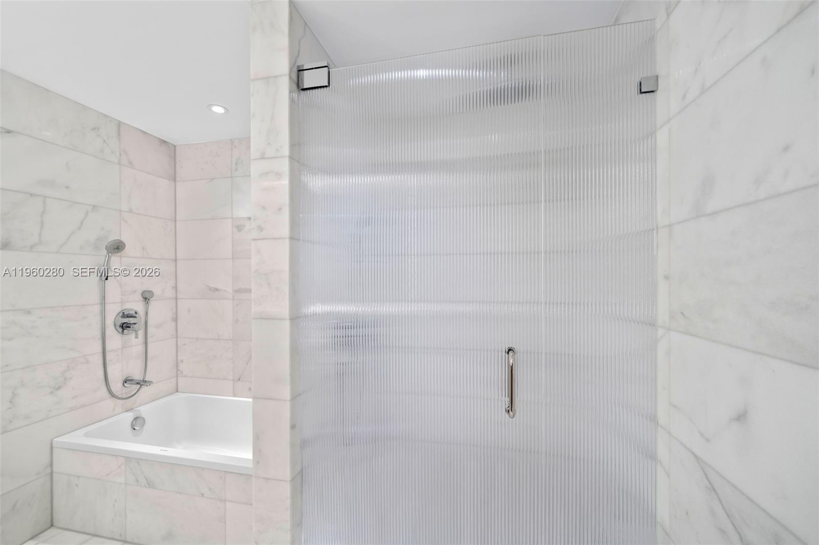 500 Alton Road, Unit 2203 Miami Beach, FL 33139 - Photo 28 of 36 a bathroom with a shower and a bathtub