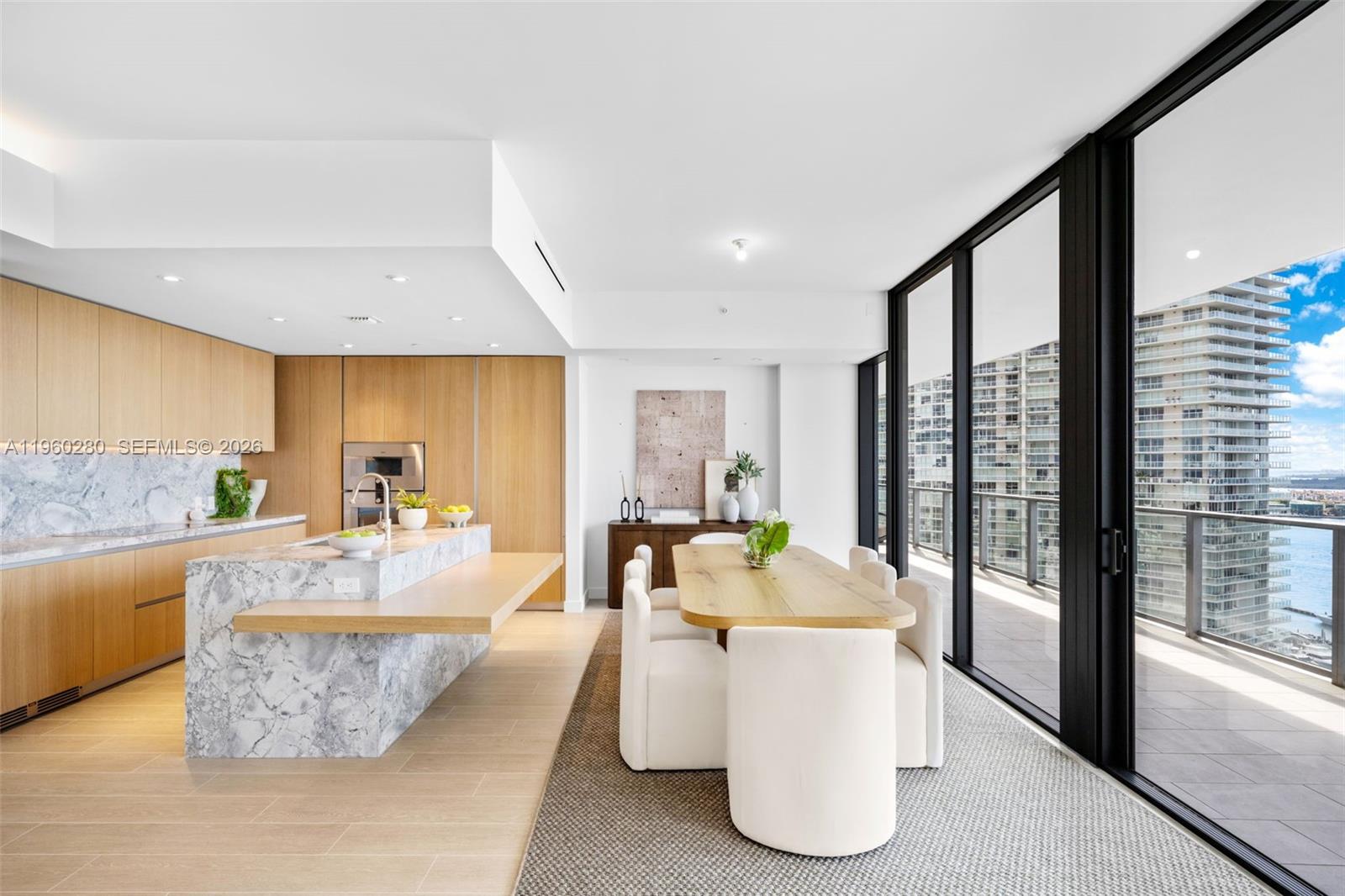 500 Alton Road, Unit 2203 Miami Beach, FL 33139 - Photo 29 of 36 a living room with couches and dining table with kitchen view