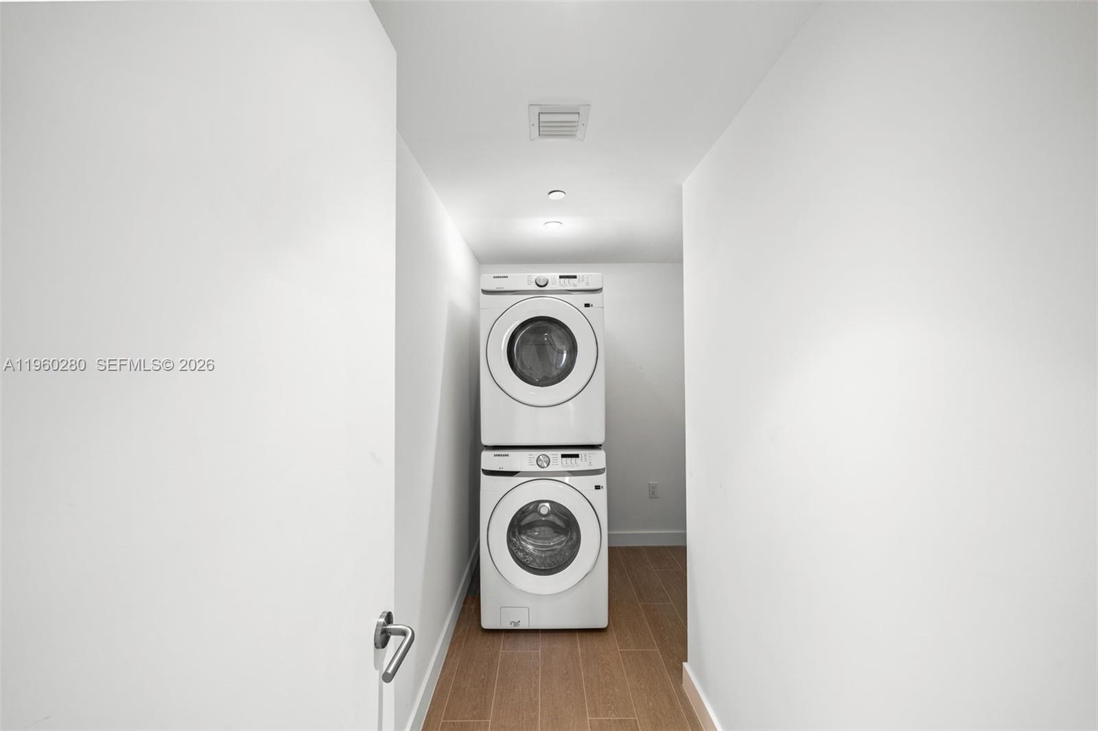 500 Alton Road, Unit 2203 Miami Beach, FL 33139 - Photo 36 of 36 a utility room with wooden floor washer and dryer
