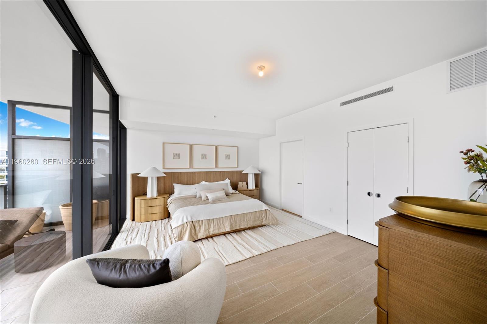 500 Alton Road, Unit 2203 Miami Beach, FL 33139 - Photo 4 of 36 a bedroom with a large bed and a couch