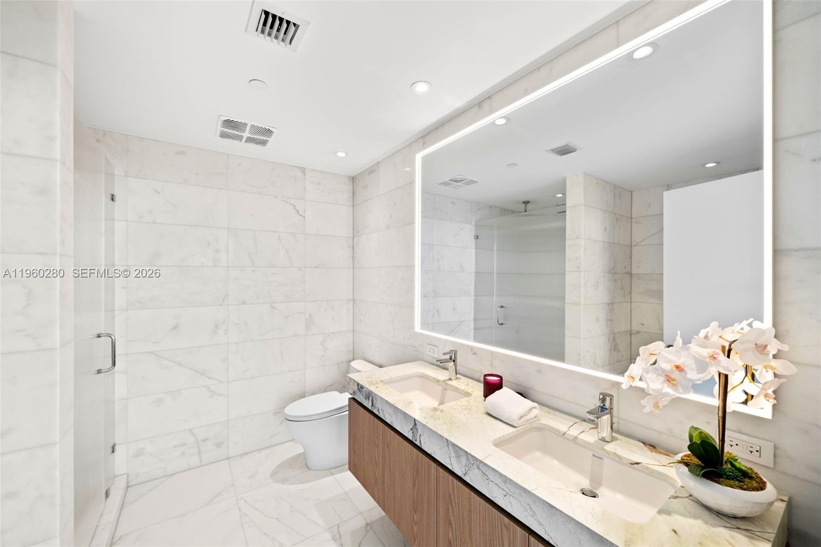 500 Alton Road, Unit 2203 Miami Beach, FL 33139 - Photo 5 of 36 a bathroom with a granite countertop sink a toilet and shower