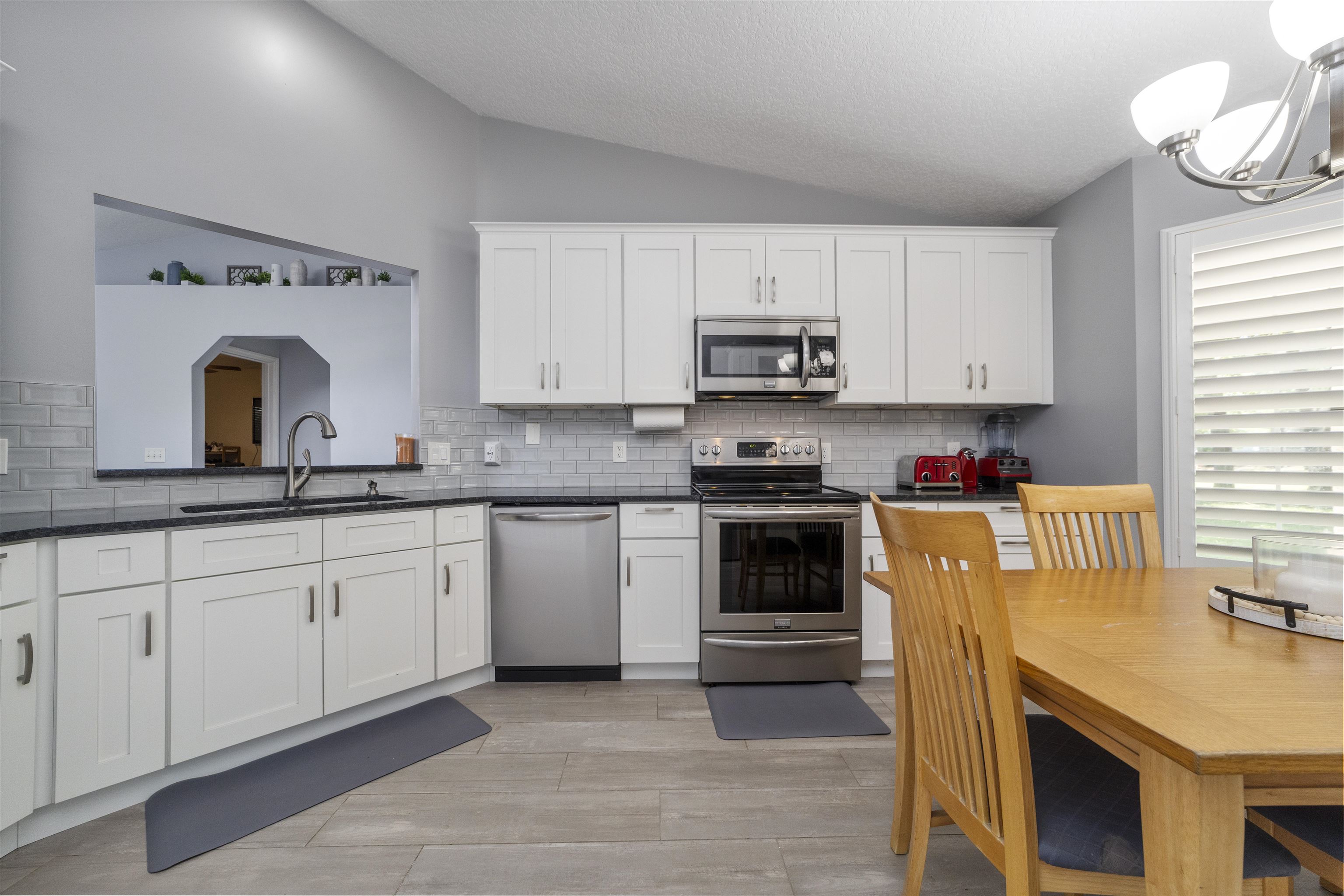 845 Wildwood Drive St. Augustine, FL 32086 - Photo 21 of 58 a kitchen with stainless steel appliances granite countertop a sink and cabinets