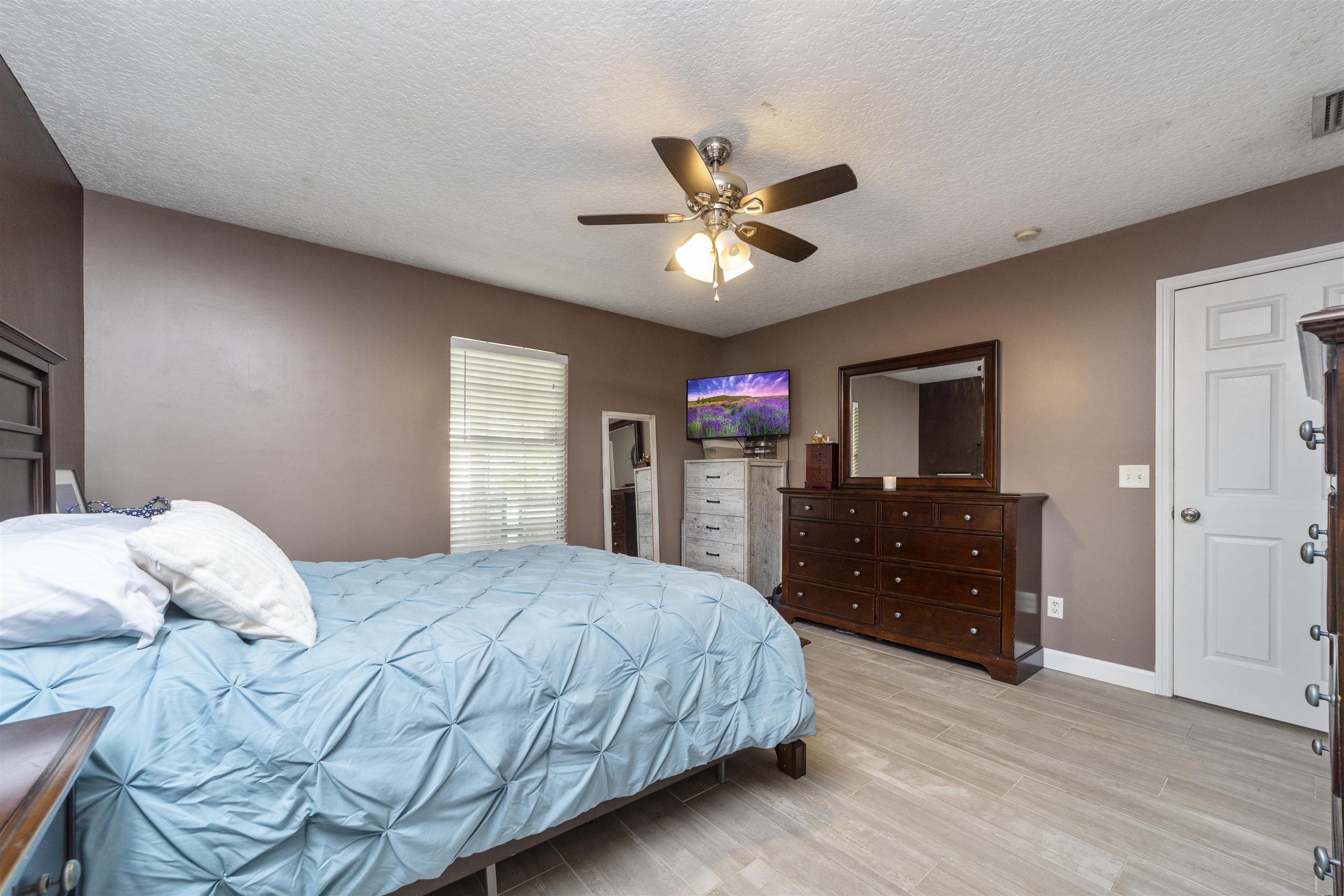 845 Wildwood Drive St. Augustine, FL 32086 - Photo 23 of 58 a bedroom with a bed and a dresser