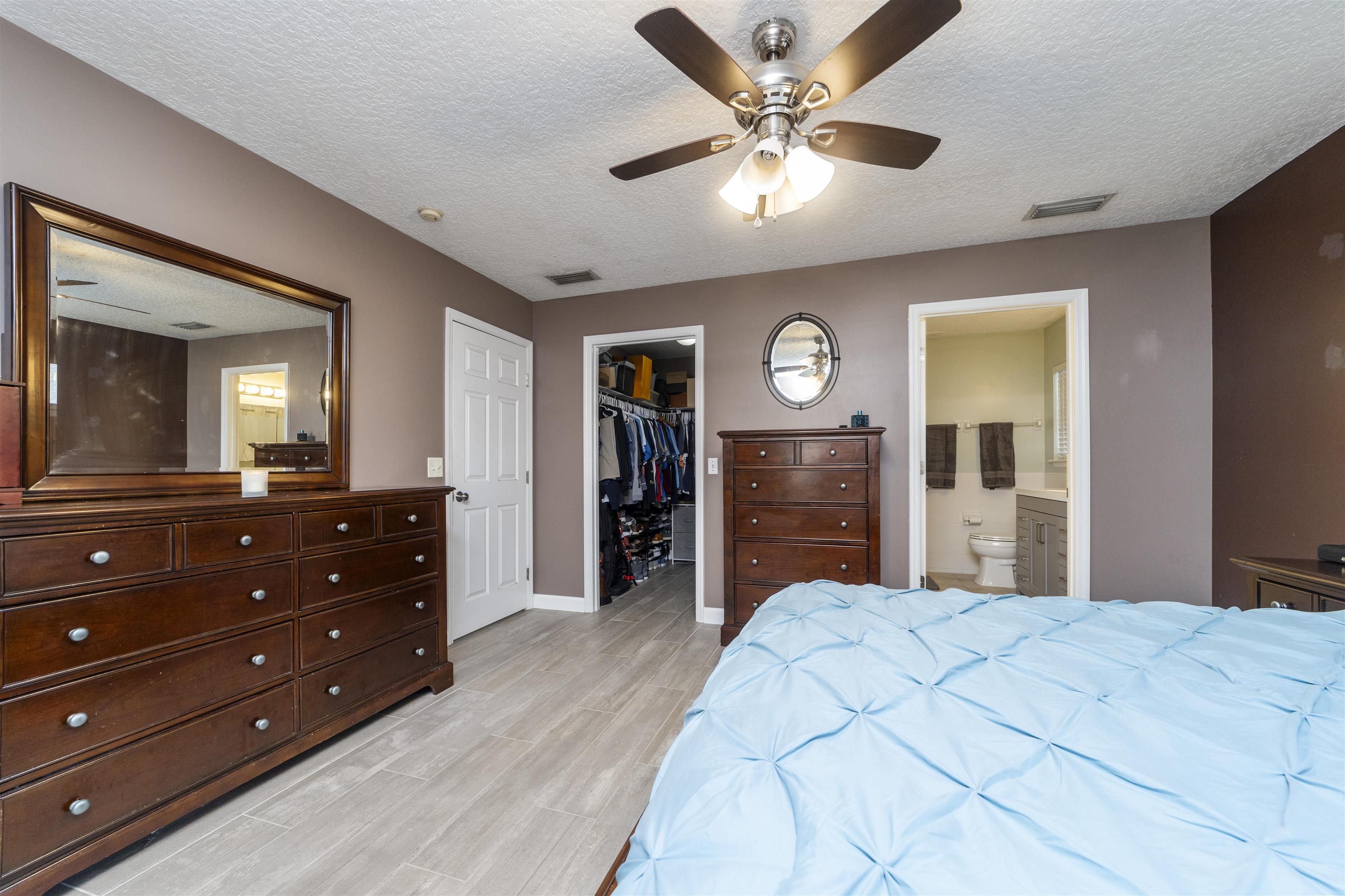 845 Wildwood Drive St. Augustine, FL 32086 - Photo 25 of 58 a bedroom with a bed and a dresser
