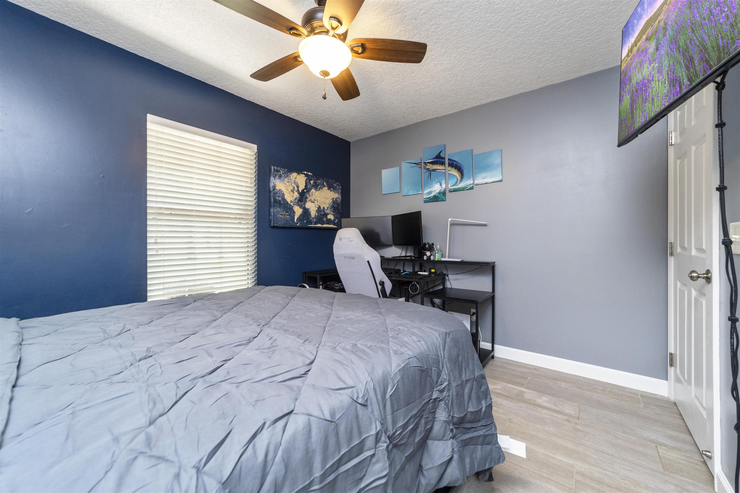 845 Wildwood Drive St. Augustine, FL 32086 - Photo 29 of 58 a bedroom with a bed and a chandelier