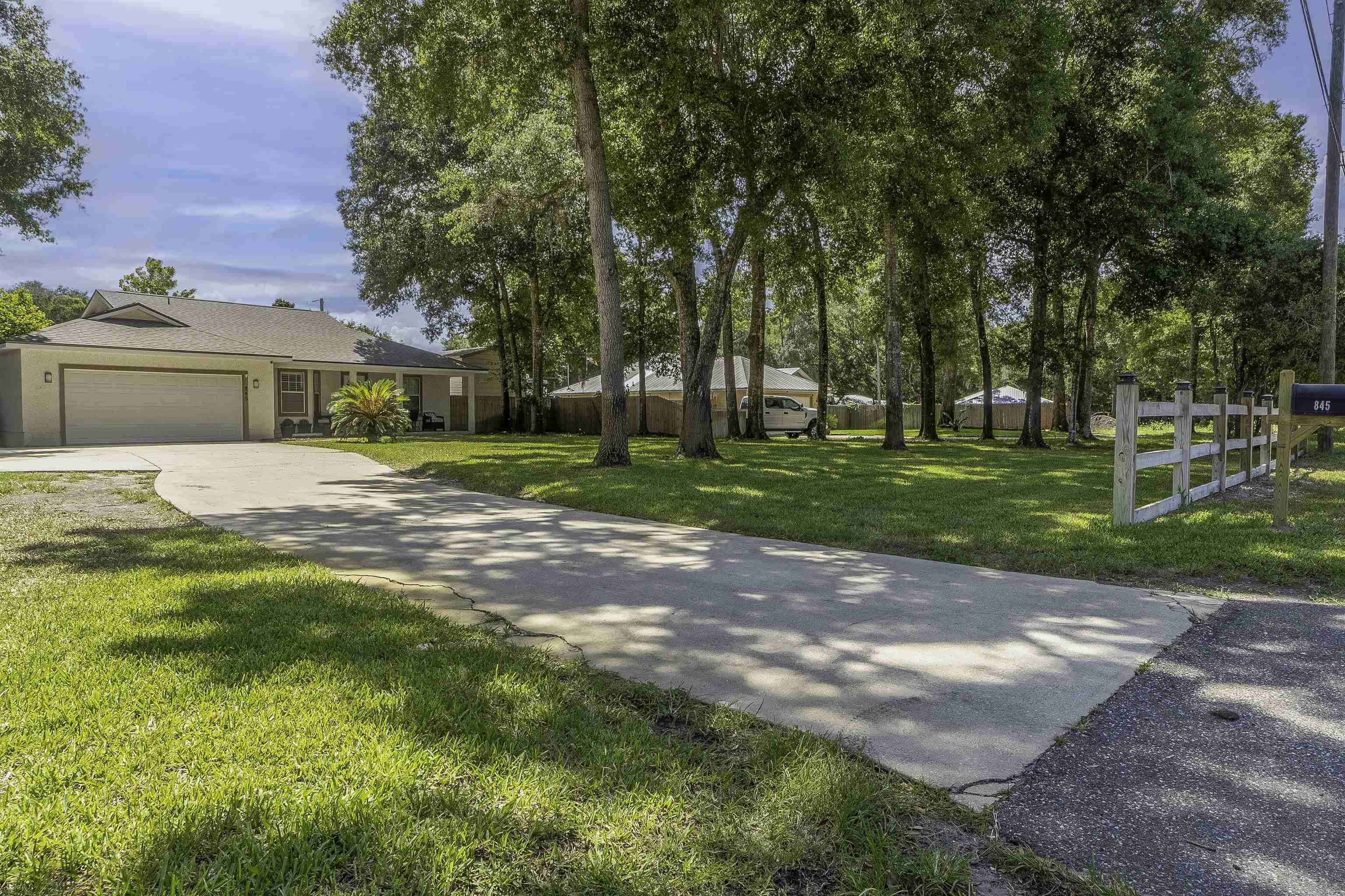 845 Wildwood Drive St. Augustine, FL 32086 - Photo 3 of 58 a front view of a house with a yard and trees