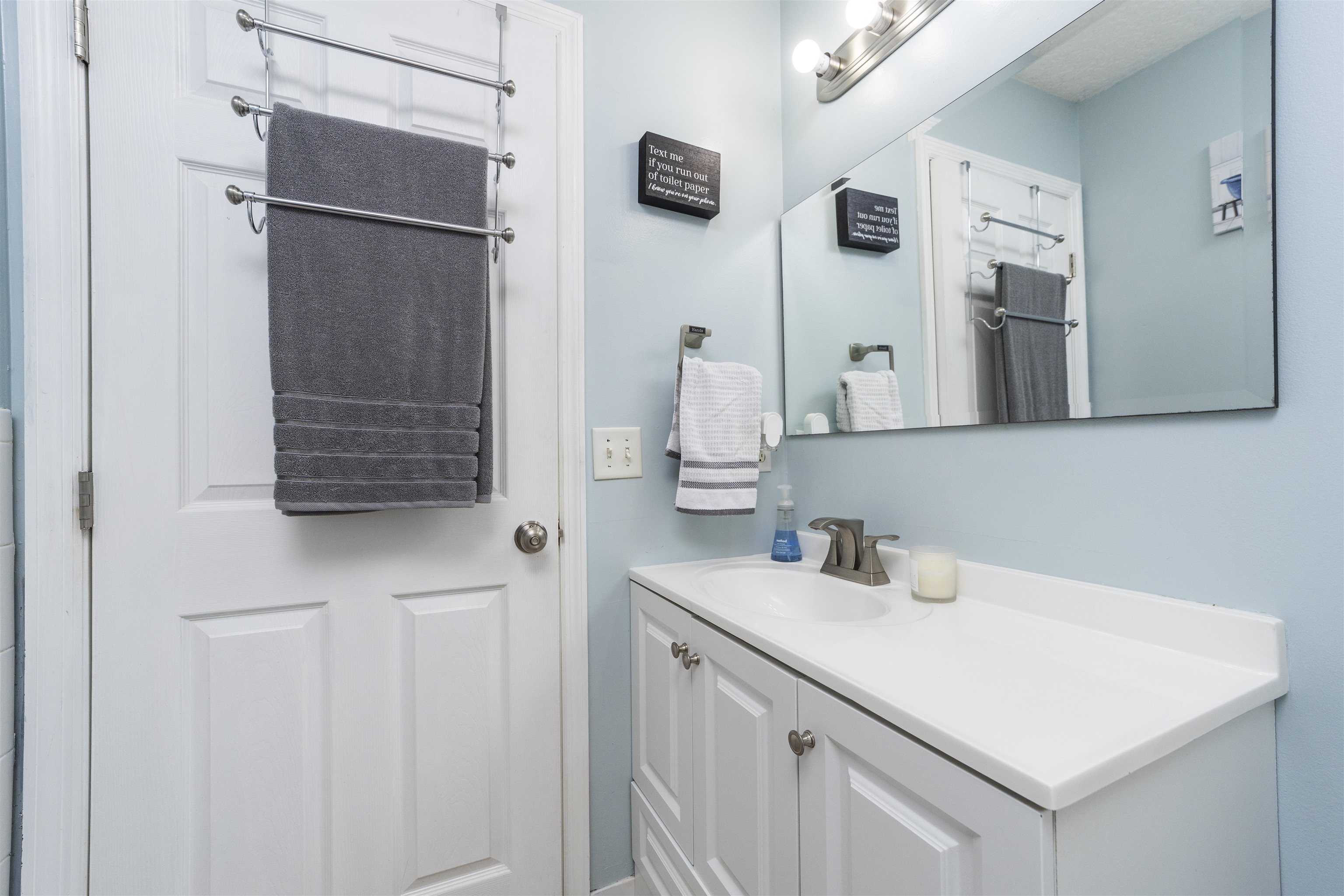 845 Wildwood Drive St. Augustine, FL 32086 - Photo 31 of 58 a bathroom with a sink vanity and a mirror