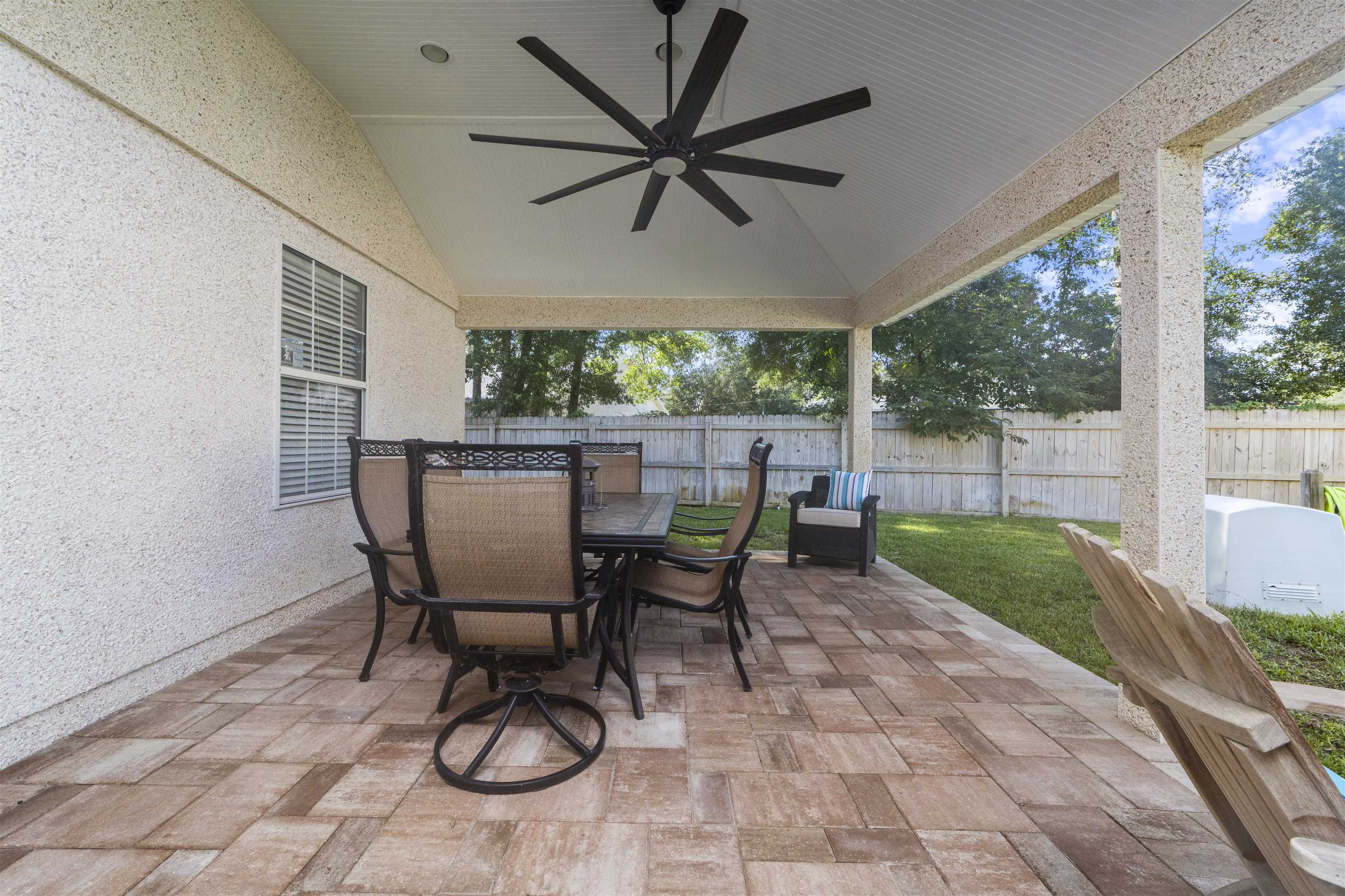 845 Wildwood Drive St. Augustine, FL 32086 - Photo 41 of 58 a view of a patio with a table chairs and a backyard