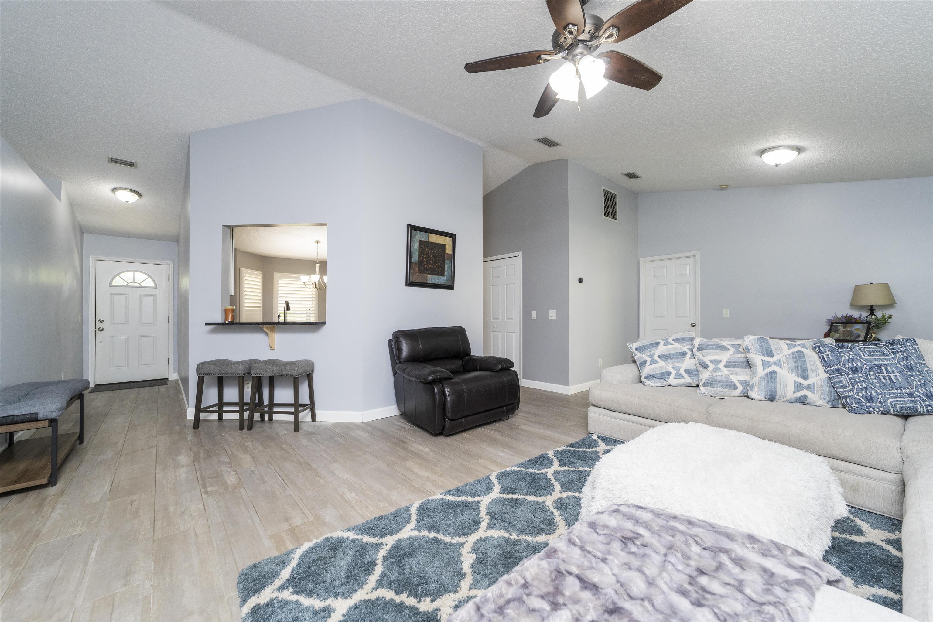 845 Wildwood Drive St. Augustine, FL 32086 - Photo 7 of 58 a living room with furniture and a wooden floor