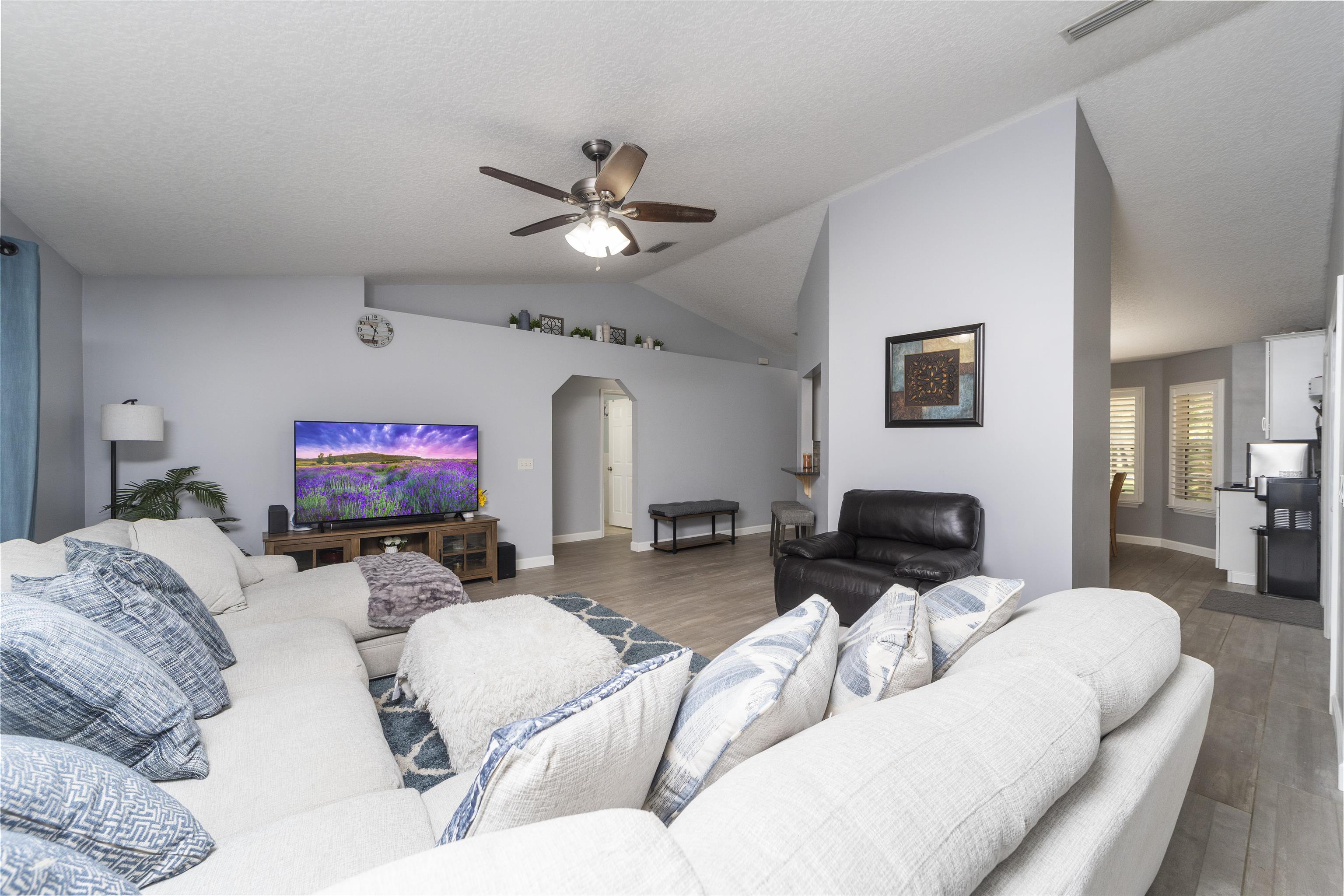 845 Wildwood Drive St. Augustine, FL 32086 - Photo 8 of 58 a living room with furniture a flat screen tv and a couch