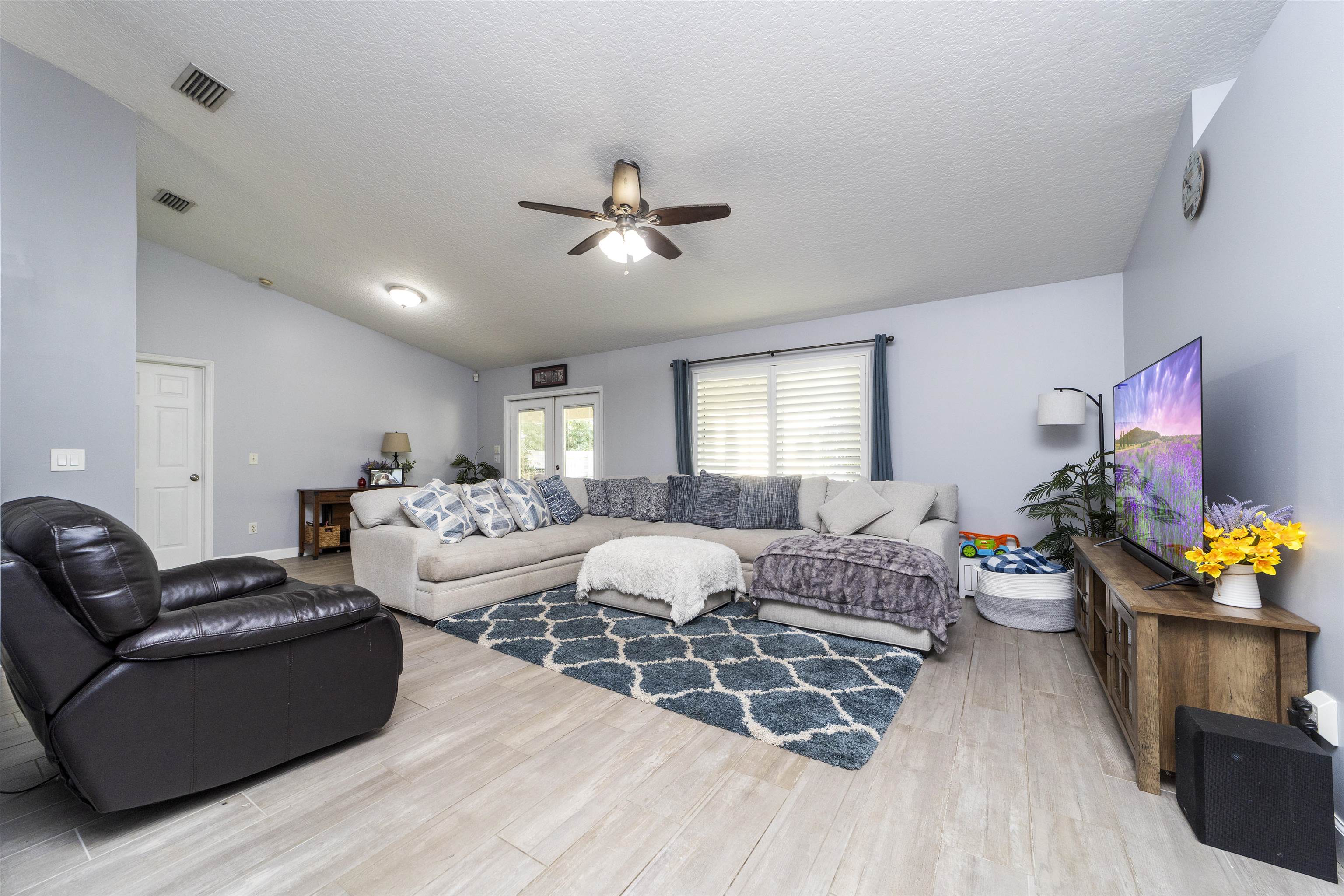 845 Wildwood Drive St. Augustine, FL 32086 - Photo 9 of 58 a living room with furniture a fireplace and a flat screen tv