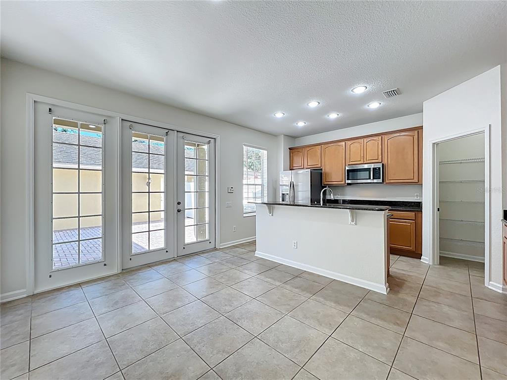 12930 Vennetta Way Windermere, FL 34786 - Photo 5 of 38 a view of kitchen with stainless steel appliances granite countertop a refrigerator and a sink