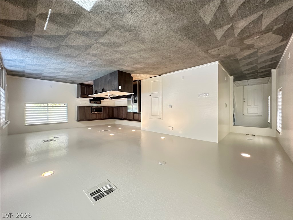 6784 Pivot Point Street Las Vegas, NV 89148 - Photo 3 of 27 A well-lit, open-concept kitchen and living area showcases rich cabinetry and seamless flooring.