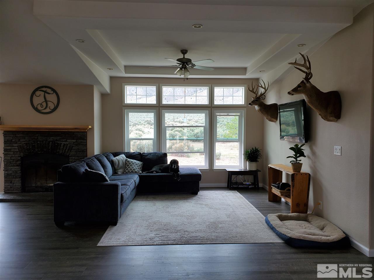 1223 Alum Rock Road Reno, NV 89506 - Photo 2 of 21 a living room with furniture large window and fireplace