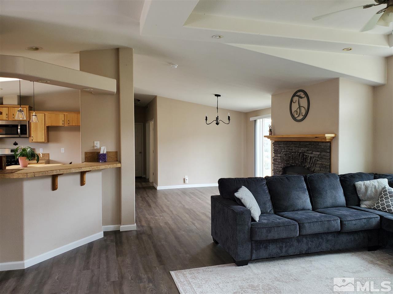 1223 Alum Rock Road Reno, NV 89506 - Photo 7 of 21 a living room with furniture a fireplace and wooden floor
