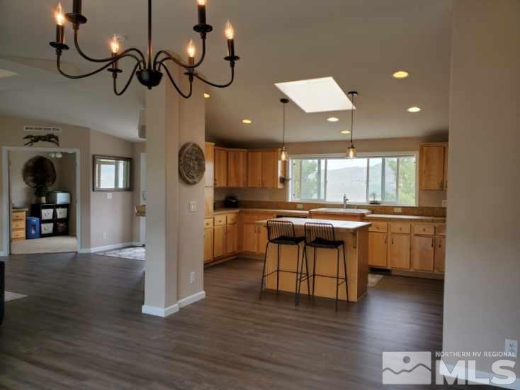1223 Alum Rock Road Reno, NV 89506 - Photo 9 of 21 a kitchen with stainless steel appliances granite countertop a white cabinets and wooden floor