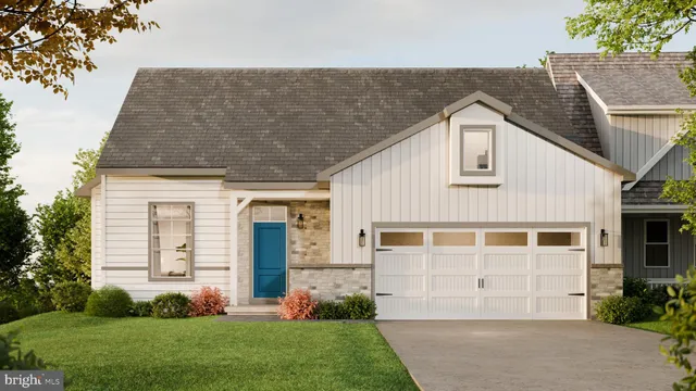a front view of a house with a garden and plants
