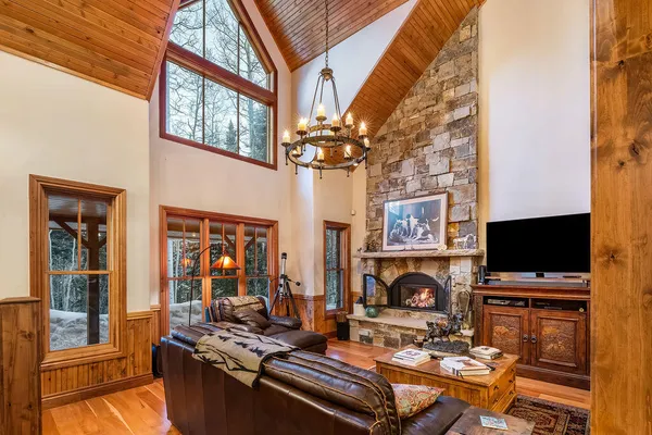 a living room with furniture fireplace and wooden floor