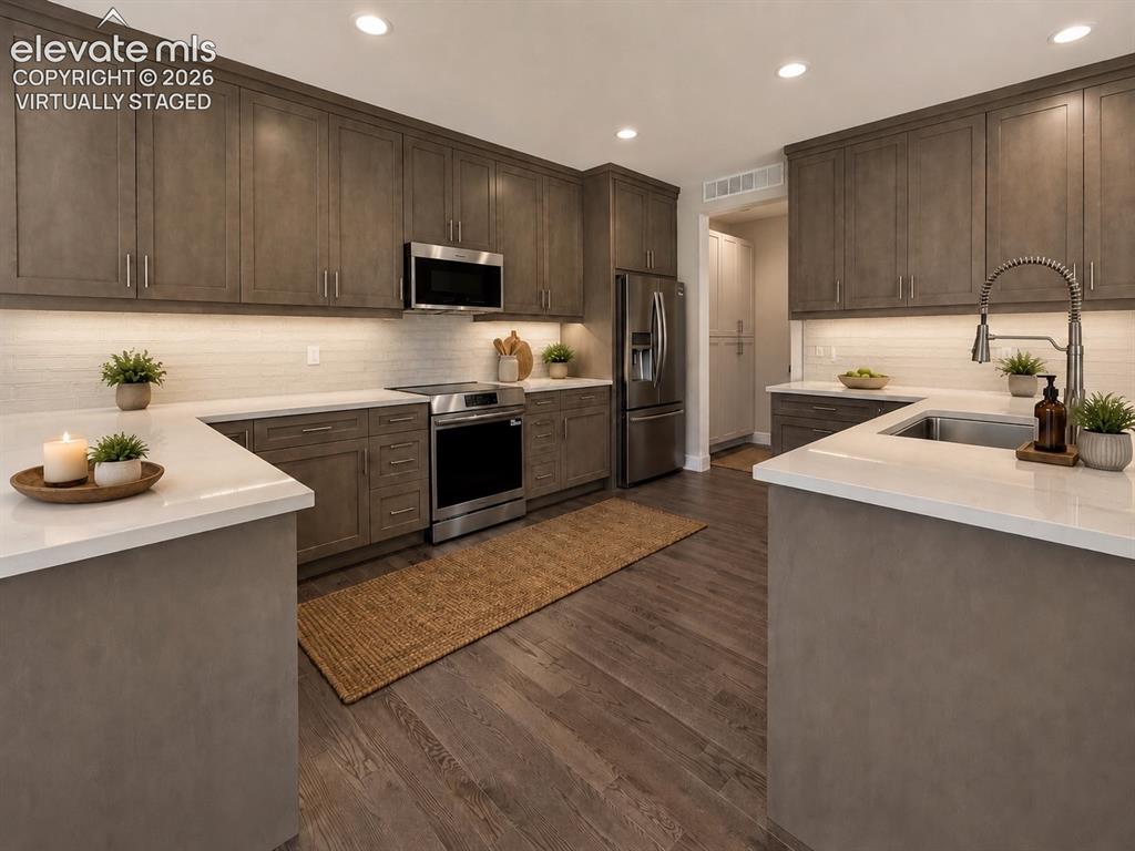 3145 Promise Point Colorado Springs, CO 80921 - Photo 9 of 28 Gourmet Kitchen with Quartz Countertops, Stainless Steel Appliances, and Induction Range. Virtually Staged.