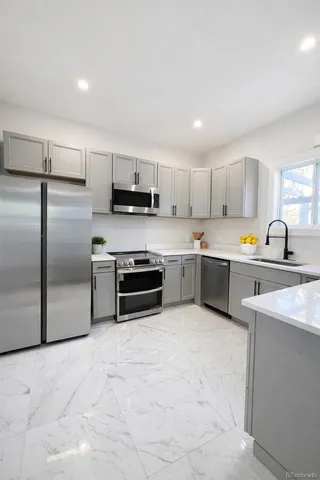 a utility room with wooden floor washer and dryer