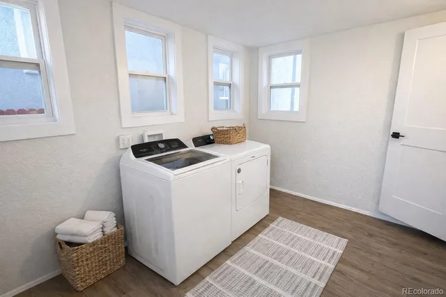 a view of an empty room with wooden floor and closet