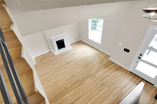 a view of hallway with wooden floor