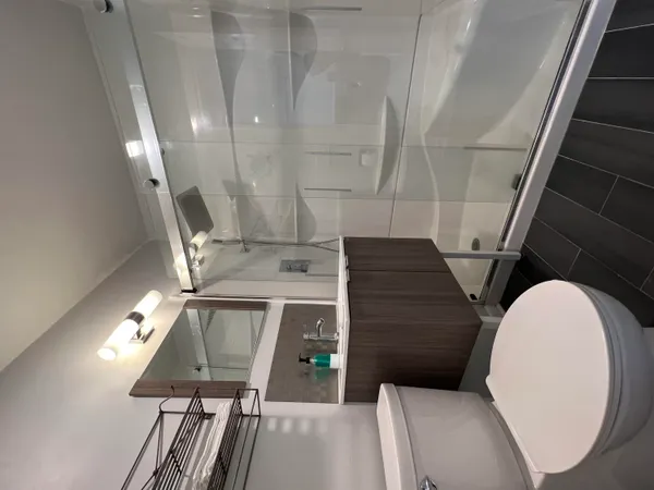 a bathroom with a sink a toilet and shower