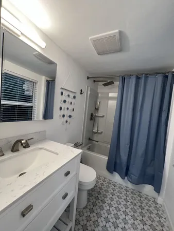 a bathroom with a shower and a sink
